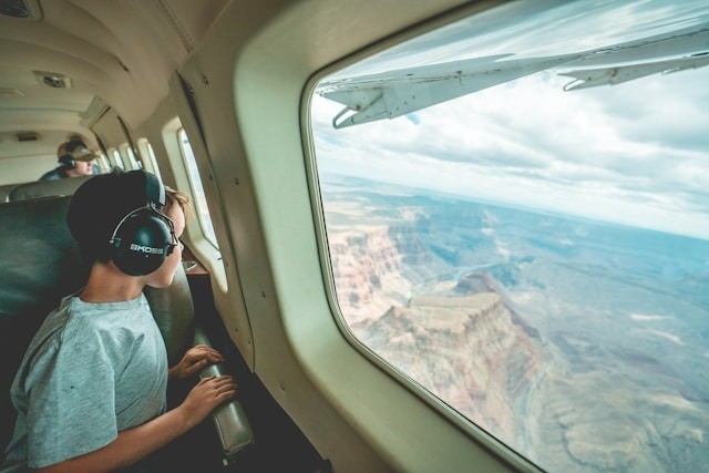 A child looking out the airplane window