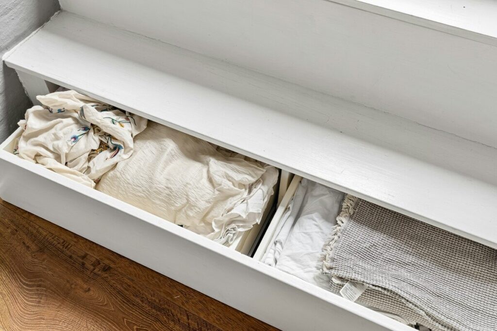 Some drawers with white clothes